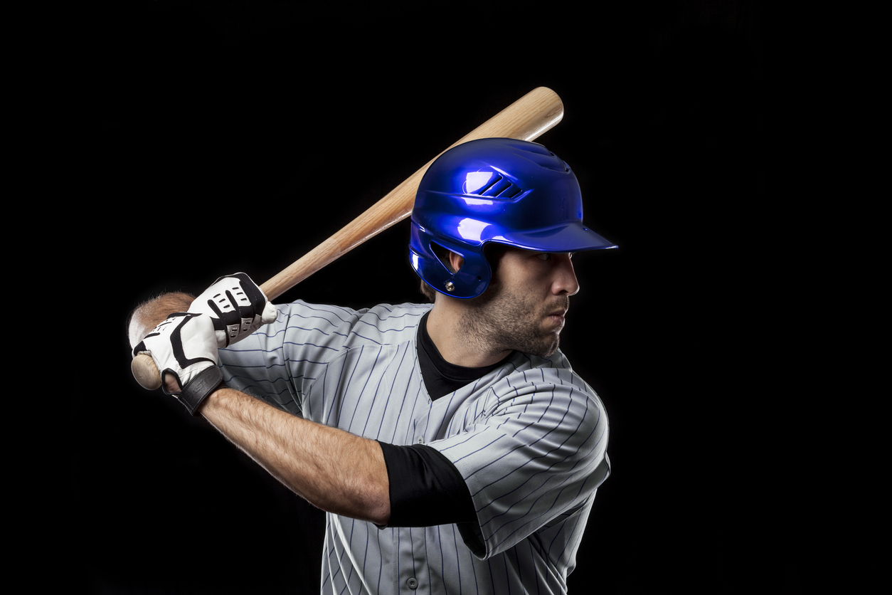 A baseball player with a blue helmet ready to hit a ball