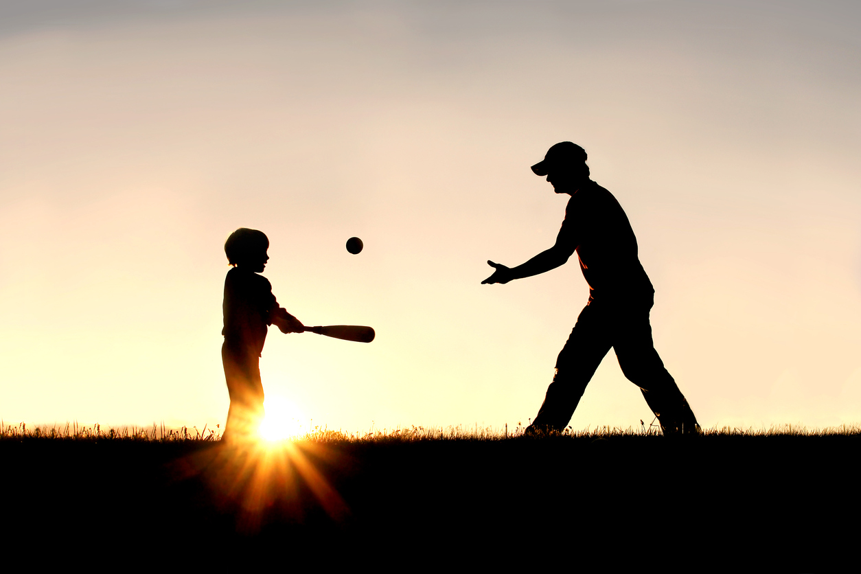 Silhouette of Father and Son Playing Baseball Outside