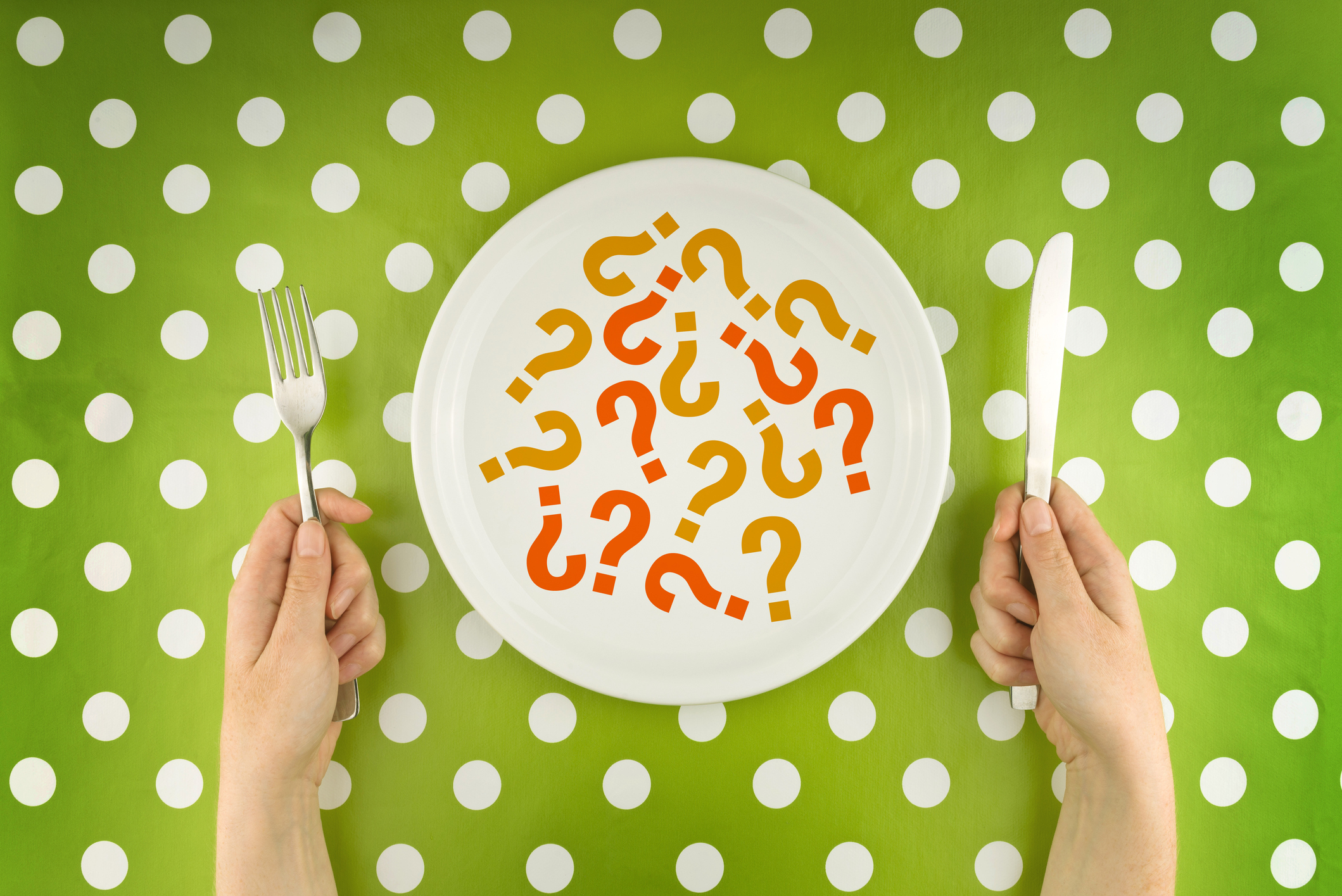 Woman eating question marks on a white plate, top view. Unknown or unredcognizable food concept.