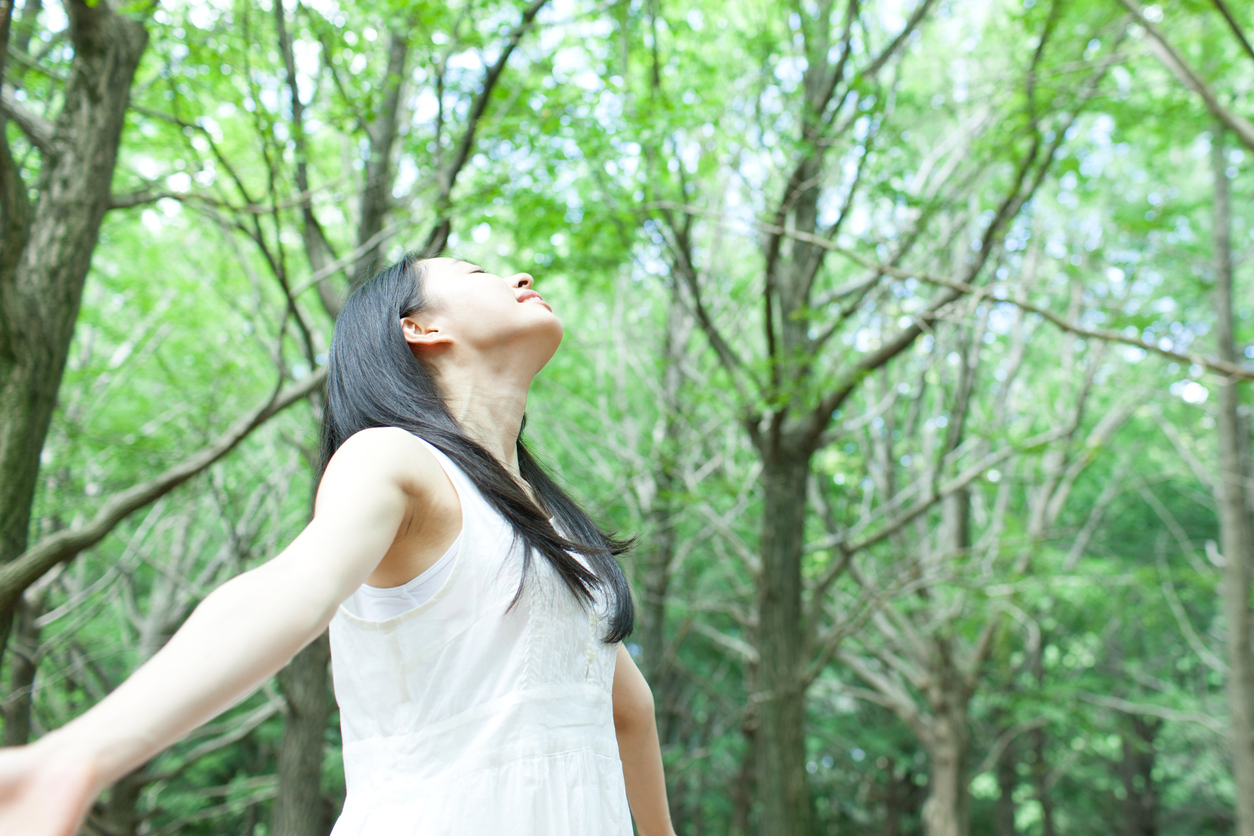 Japanese woman holding breath in a park